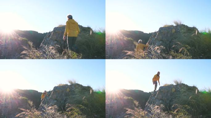 成熟的男性徒步旅行者到达远山的顶峰观景台