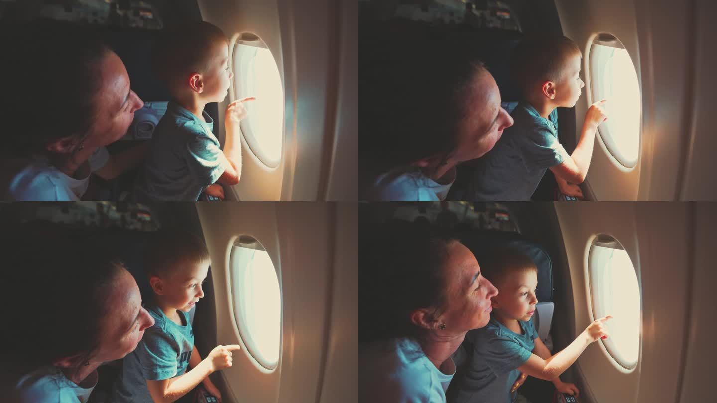 妈妈带着小男孩坐飞机。他们望向窗外，男孩用手指着天空、云彩和自然景观，兴致勃勃地鸟瞰。游客带孩子旅游