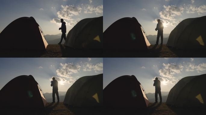 旅行者在山上露营和拍照