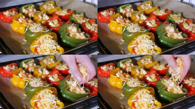 女人的手撒上切碎的奶酪红辣椒分成两半，黄的，红的，绿的，好吃的，里面塞着烤好的肉，上面撒上奶酪