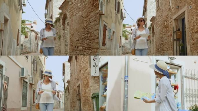 中年成年妇女手持地图，走在克罗地亚历史建筑的街道上