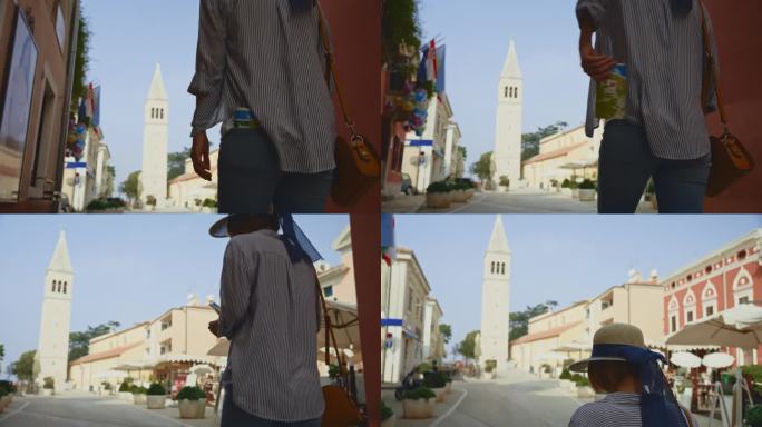 克罗地亚罗维尼，一名女游客从口袋里掏出地图，走向教堂塔