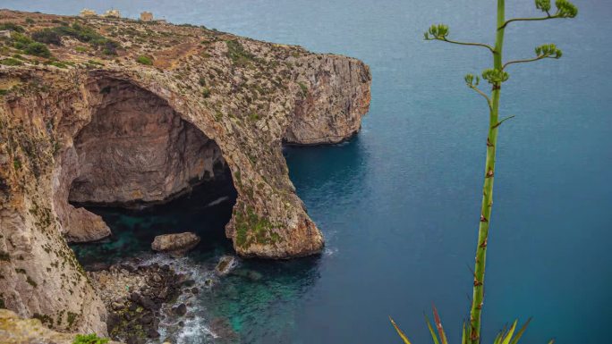 蓝洞-天然石拱与海洞和龙舌兰植物在Qrendi，马耳他。高角度，延时