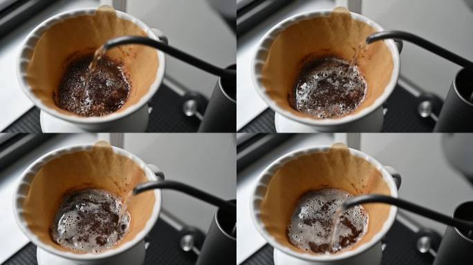 有人用滤纸将热水倒在咖啡粉上，以制作滴漏咖啡。
