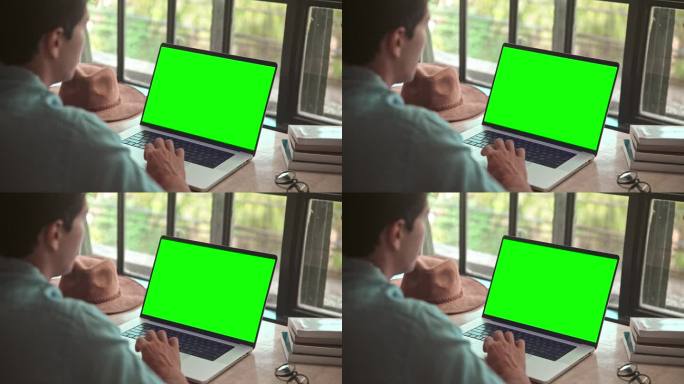 商人工作在笔记本电脑模拟绿屏色度键和键盘上输入文本特写。在网上聊天或写文件特写的人。程序员在电子邮件