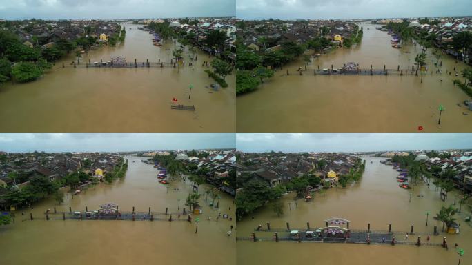 无人机拍摄的越南广南会安洪水后人们在被水淹没的街道上行走的画面