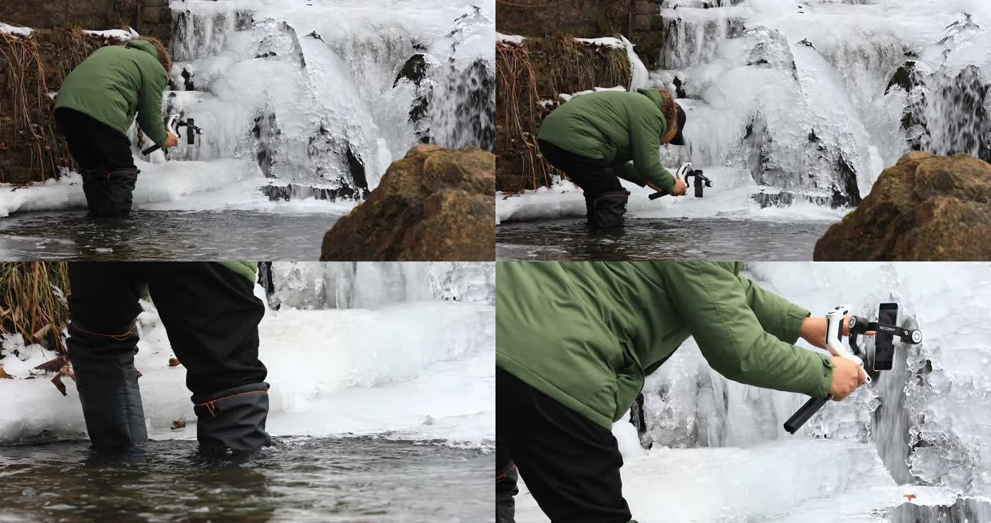 在冰雪瀑布里工作的摄影师