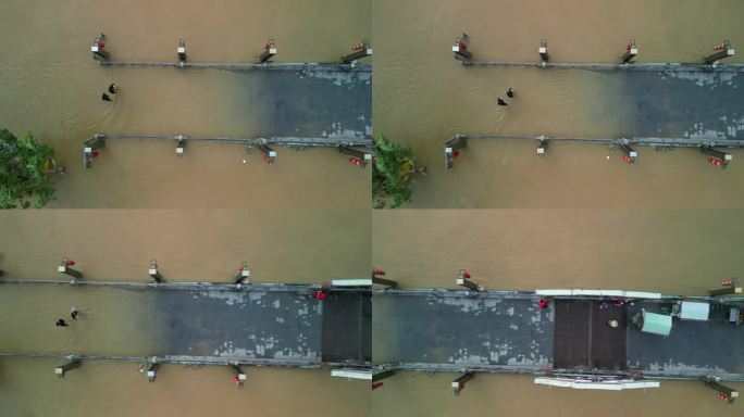 无人机拍摄的越南会安镇洪水后人们在被水淹没的街道上行走的画面