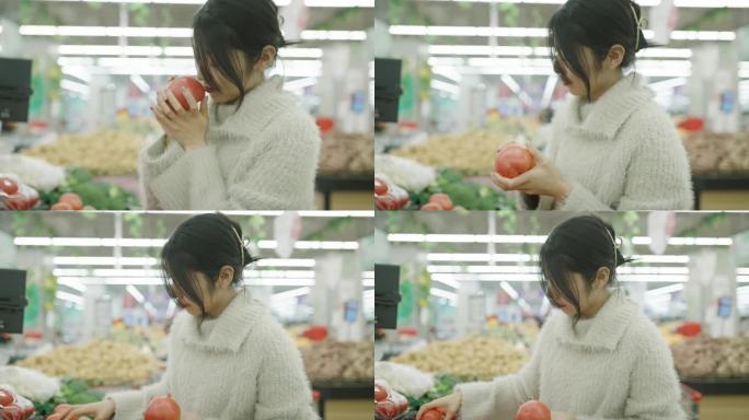 年轻妇女在超市买蔬菜
