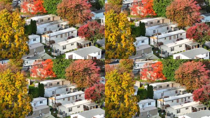 郊区有秋天树木的移动房屋。鸟瞰图拖车公园与五颜六色的树叶在秋天。