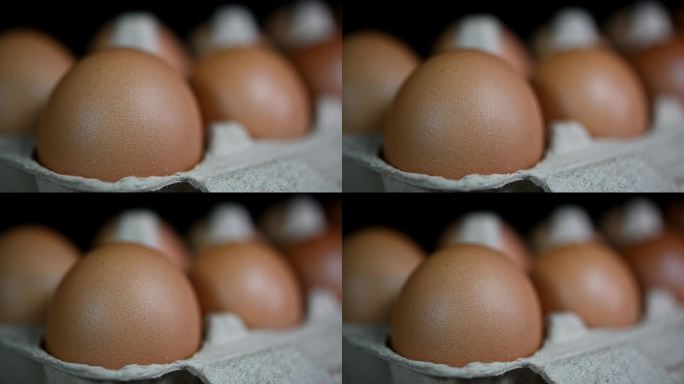 镜头变焦显示了一打鸡蛋放在纸做的托盘里，食物和烹饪。