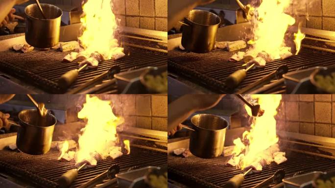 厨师准备烧烤肉在厨房烤架上明火特写。烹饪烧烤食物的人。美味多汁的肉烤在烤架上慢动作。新鲜的鸡肉餐在室