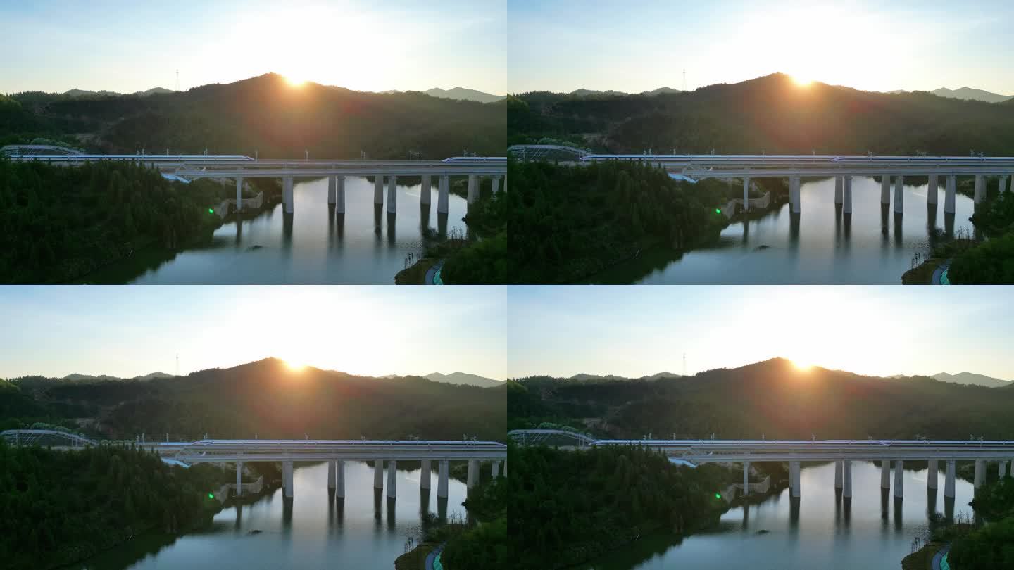 夕阳下经过桥梁的高铁动车
