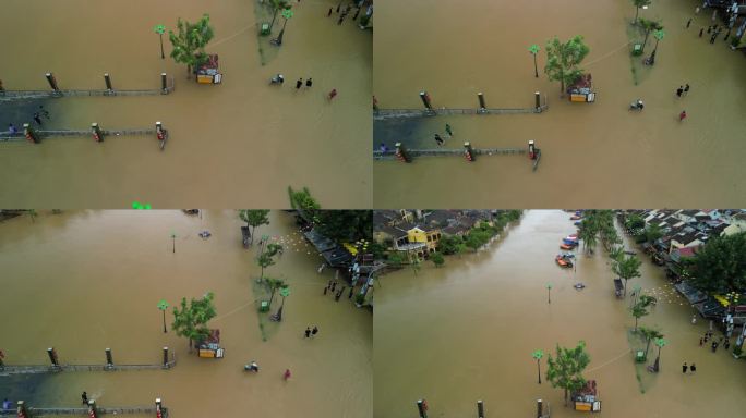 无人机拍摄的越南会安洪水后人们在被水淹没的街道上行走的画面