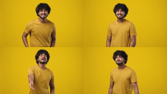 年轻的印度男子站在橘黄色的摄影棚背景上，对着镜头飞吻微笑