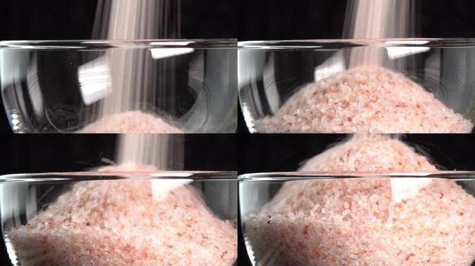粉红色喜马拉雅盐或岩盐倒在玻璃碗。微量矿物质盐用于烹饪和食物展示，装饰灯和水疗