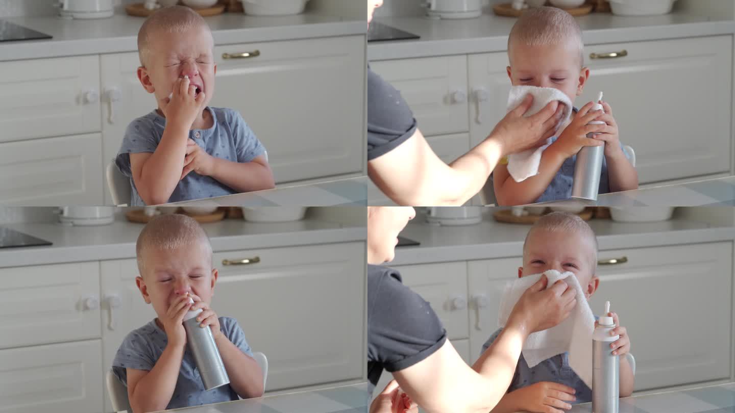 妈妈用吸鼻器和鼻喷雾器把生理盐水喷在她蹒跚学步的孩子的鼻子里，小男孩很冷，还流鼻涕