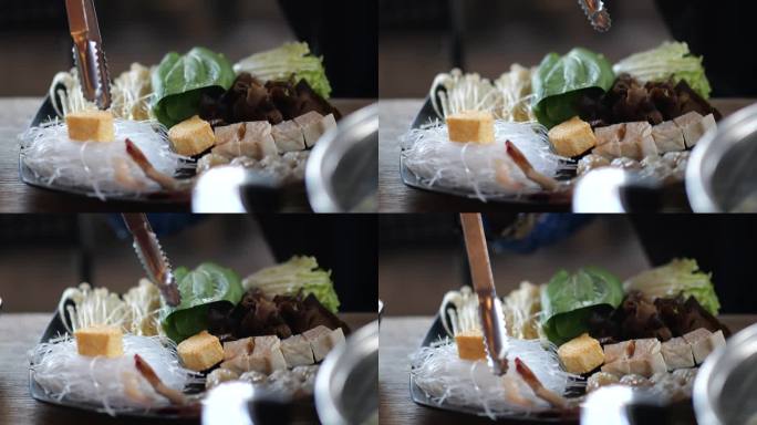涮锅或寿喜烧。日本的食物。日本餐馆里锅里的虾。在日本餐厅享用涮锅和寿喜烧。有选择性的重点。