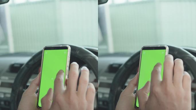 男子在车里使用绿屏智能手机，出门前查看手机应用