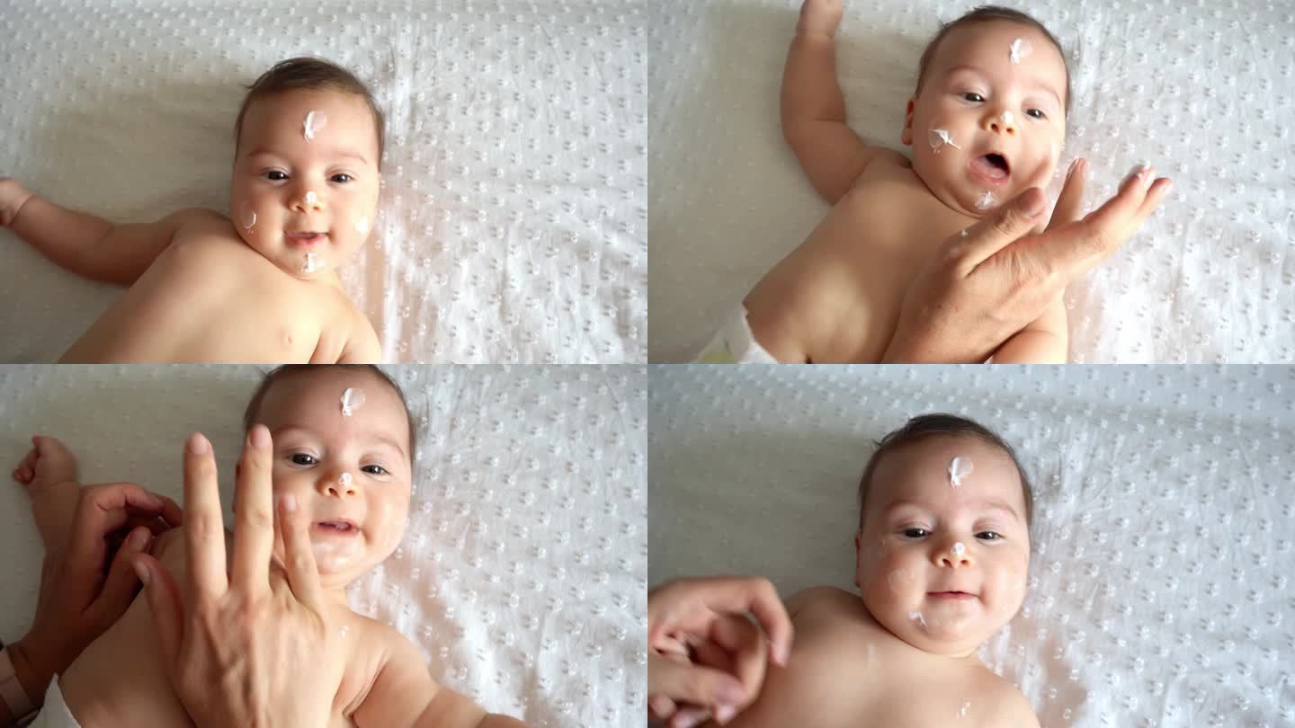 母亲把面霜涂在婴儿脸上。婴儿护肤。