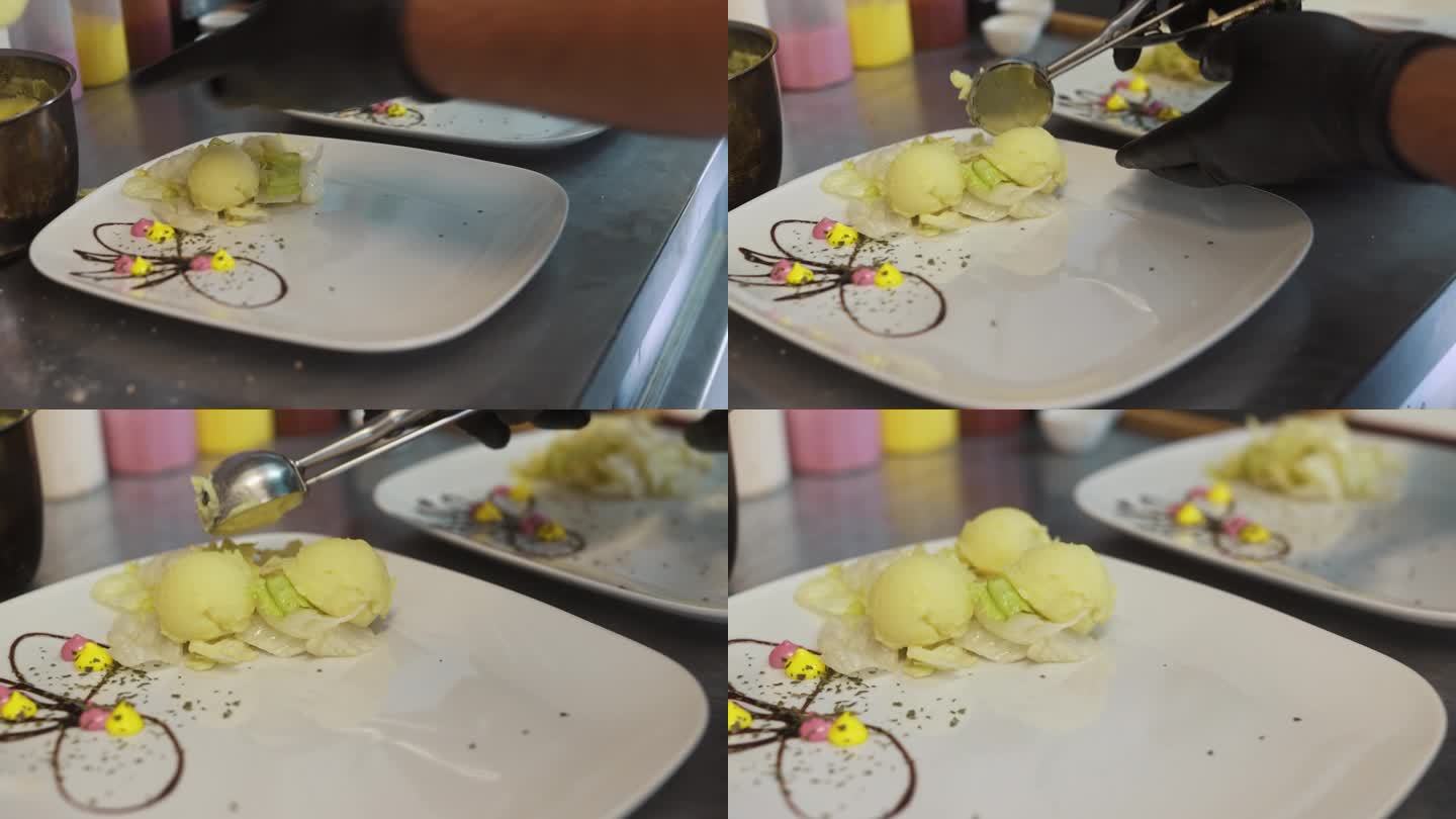 不知名的厨师戴着手套，在餐厅厨房的工作面上用两个盘子盛着果泥