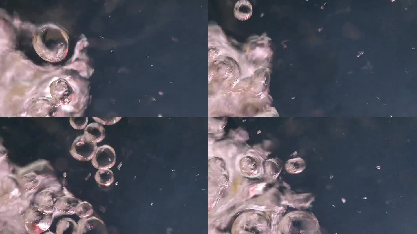 近距离视频，气泡上升的水柱，形成波浪和涟漪的水面上的金鱼水族馆