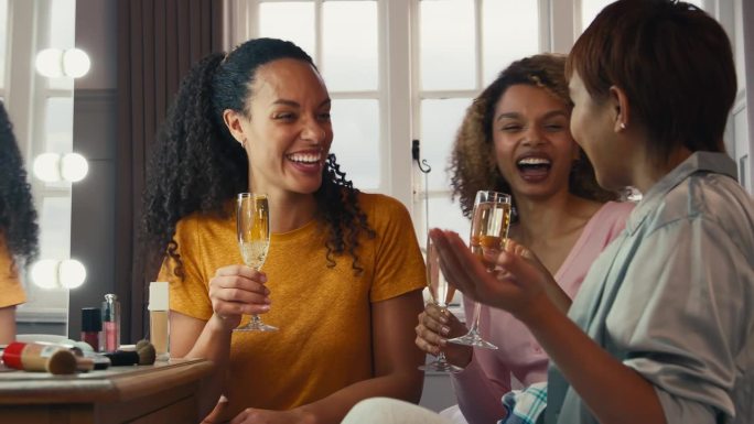 一群女性朋友在家里化妆，在晚上外出前喝香槟