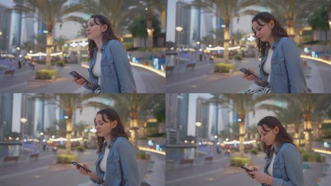 一名女子在迪拜旅游时使用智能手机