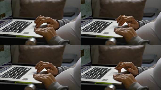 近距离拍摄孕妇在家使用笔记本电脑