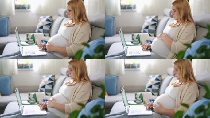 孕妇在家里客厅沙发上用笔记本电脑工作