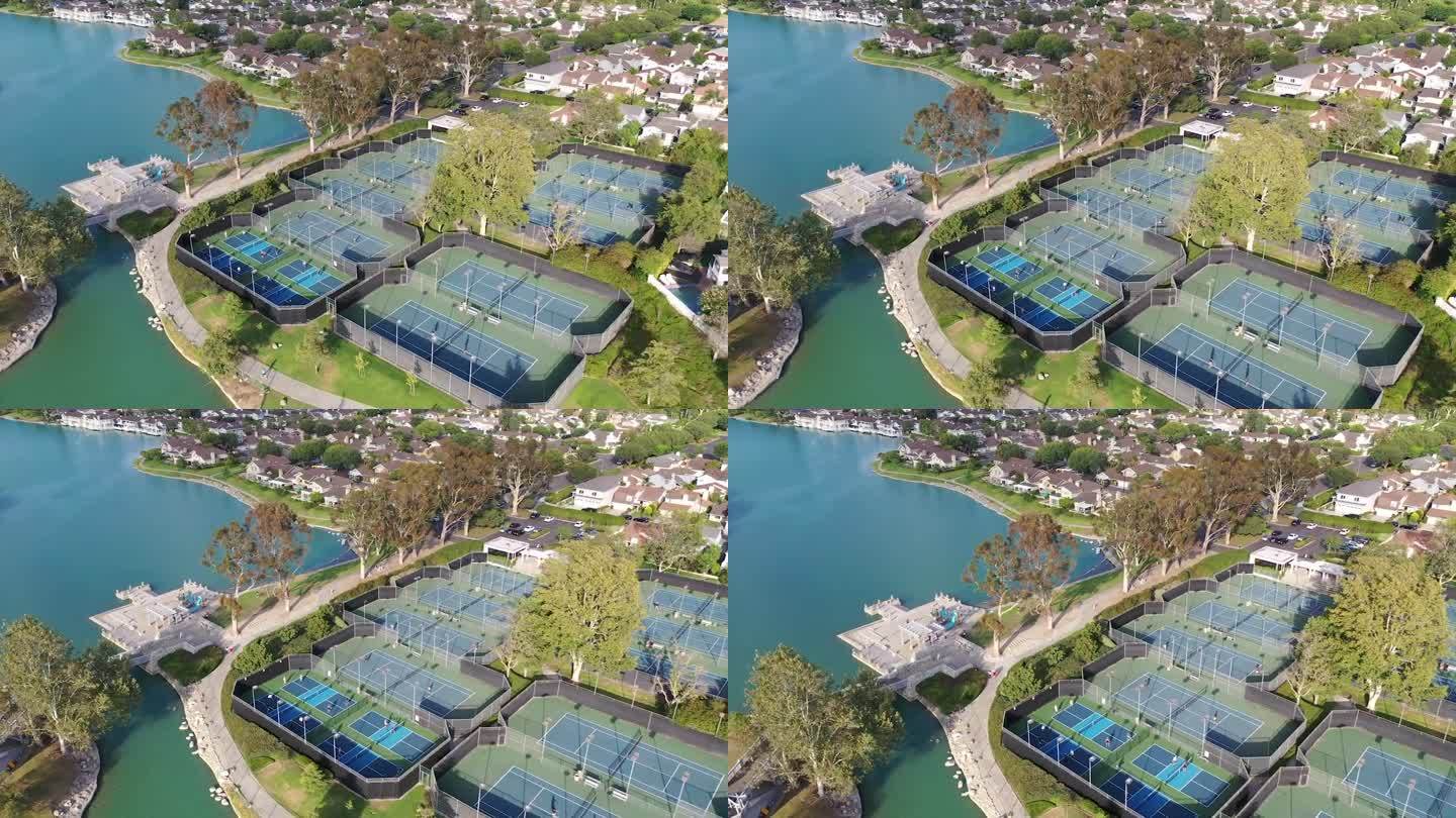 加州尔湾，无人机俯瞰伍德布里奇北湖海滩俱乐部网球场。迷人的航拍镜头捕捉到这个湖边撤退的魅力在一个温暖