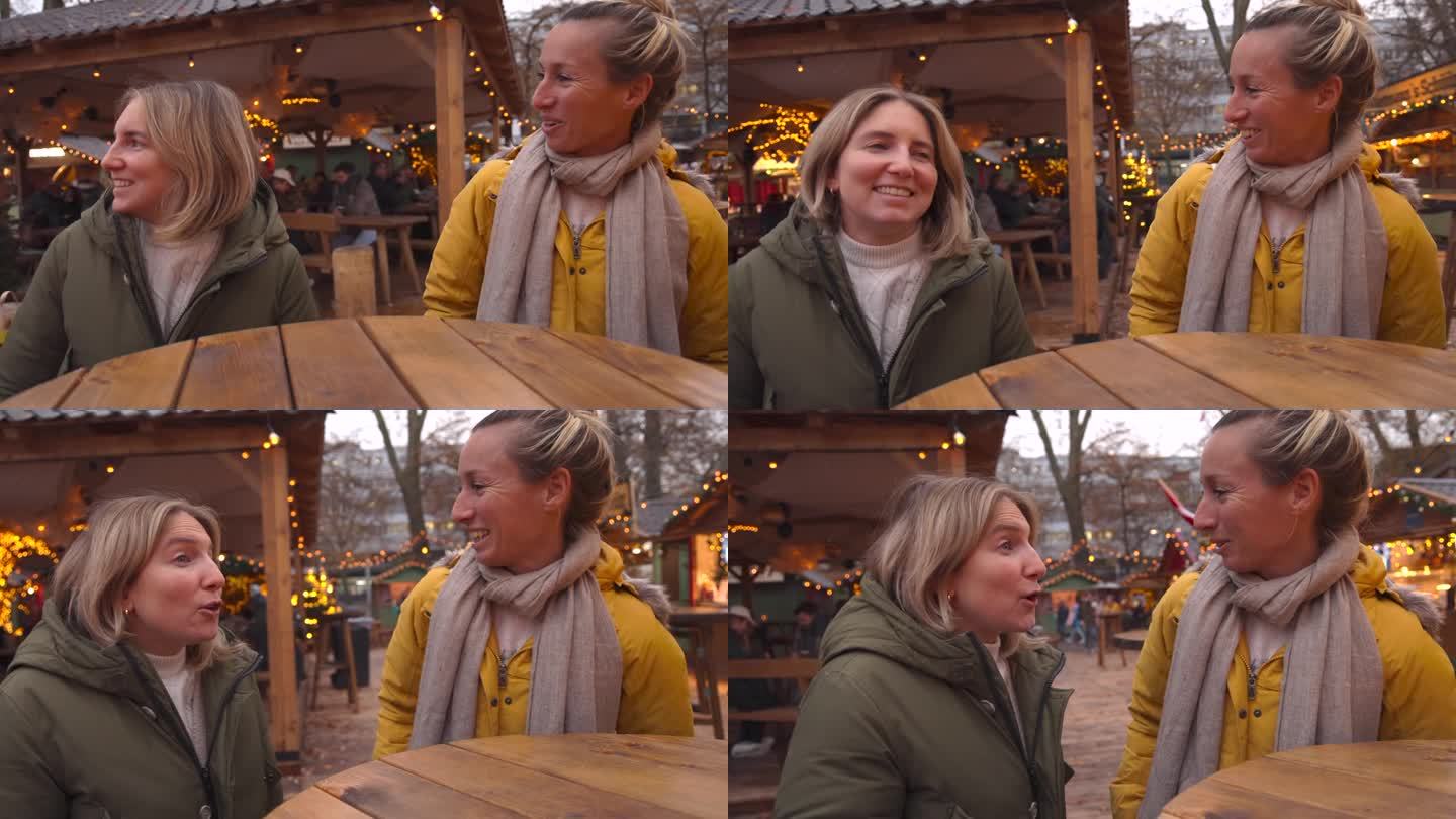 女性朋友在圣诞市场聊天