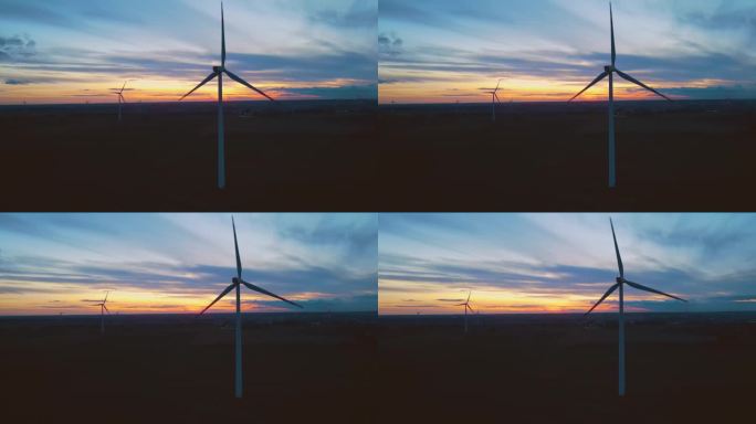 工作风电场与风车涡轮机公园鸟瞰图在惊人的多云多彩的日落