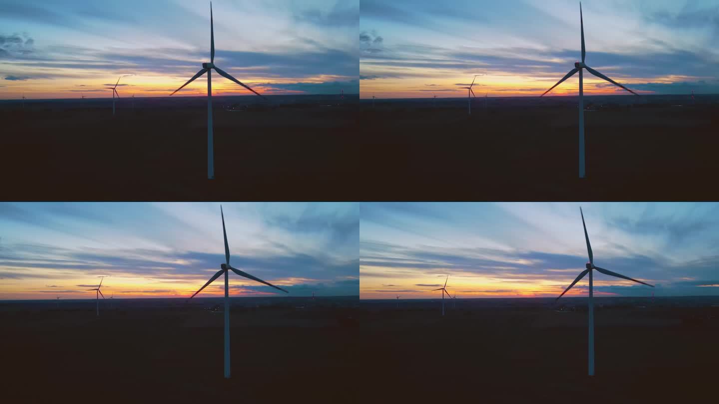 工作风电场与风车涡轮机公园鸟瞰图在惊人的多云多彩的日落