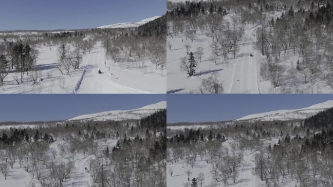 航拍雪橇车在长白山森林雪道行驶