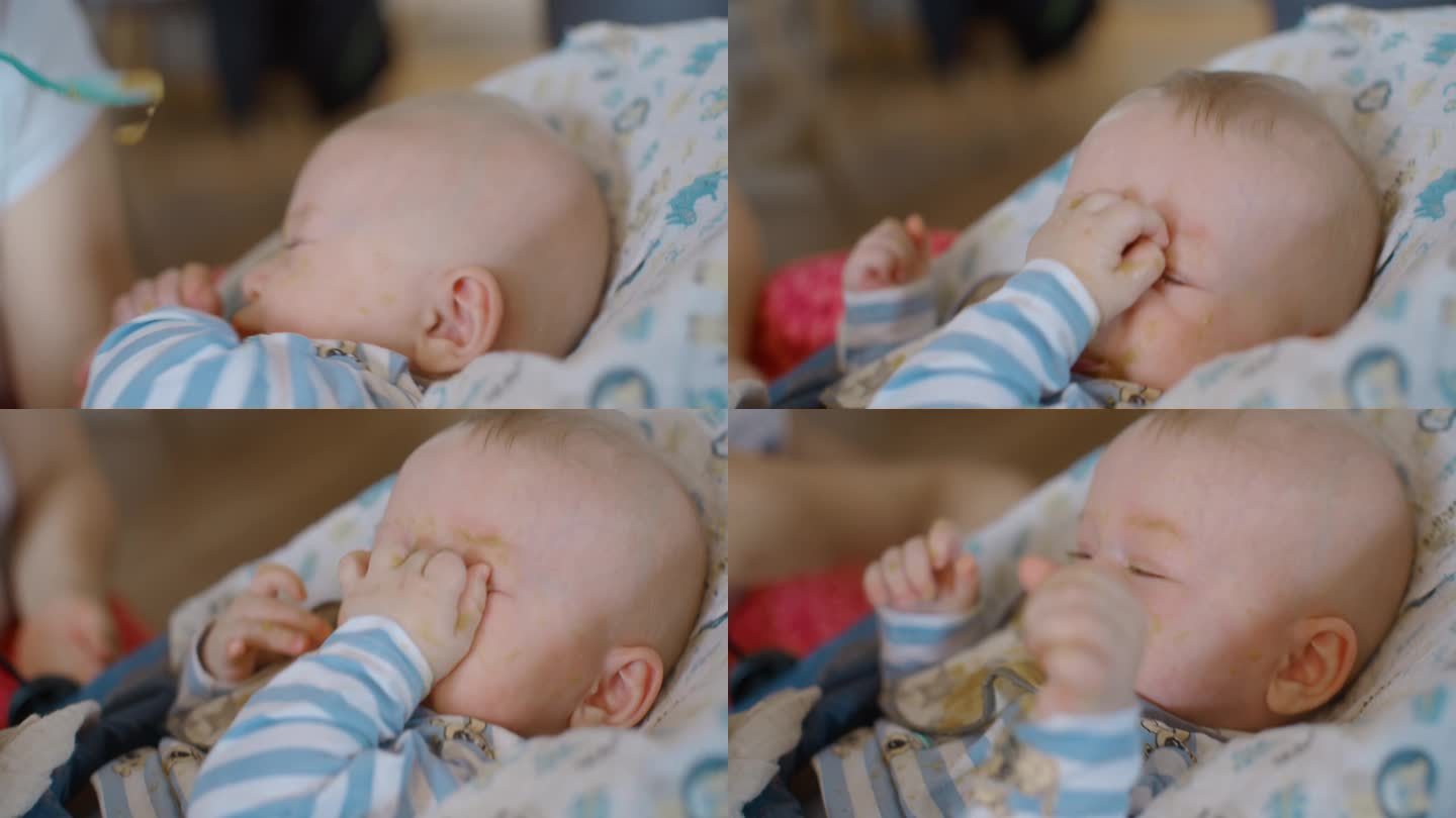 厌恶的男婴拒绝母亲在家里喂食物的近距离手持镜头
