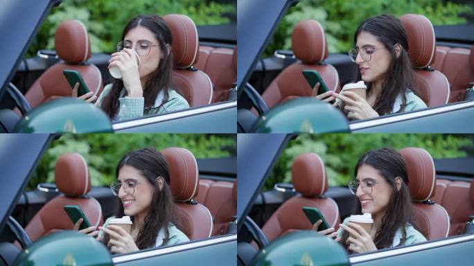 坐在车里看手机喝咖啡的女人。女司机坐在敞篷车里玩手机。