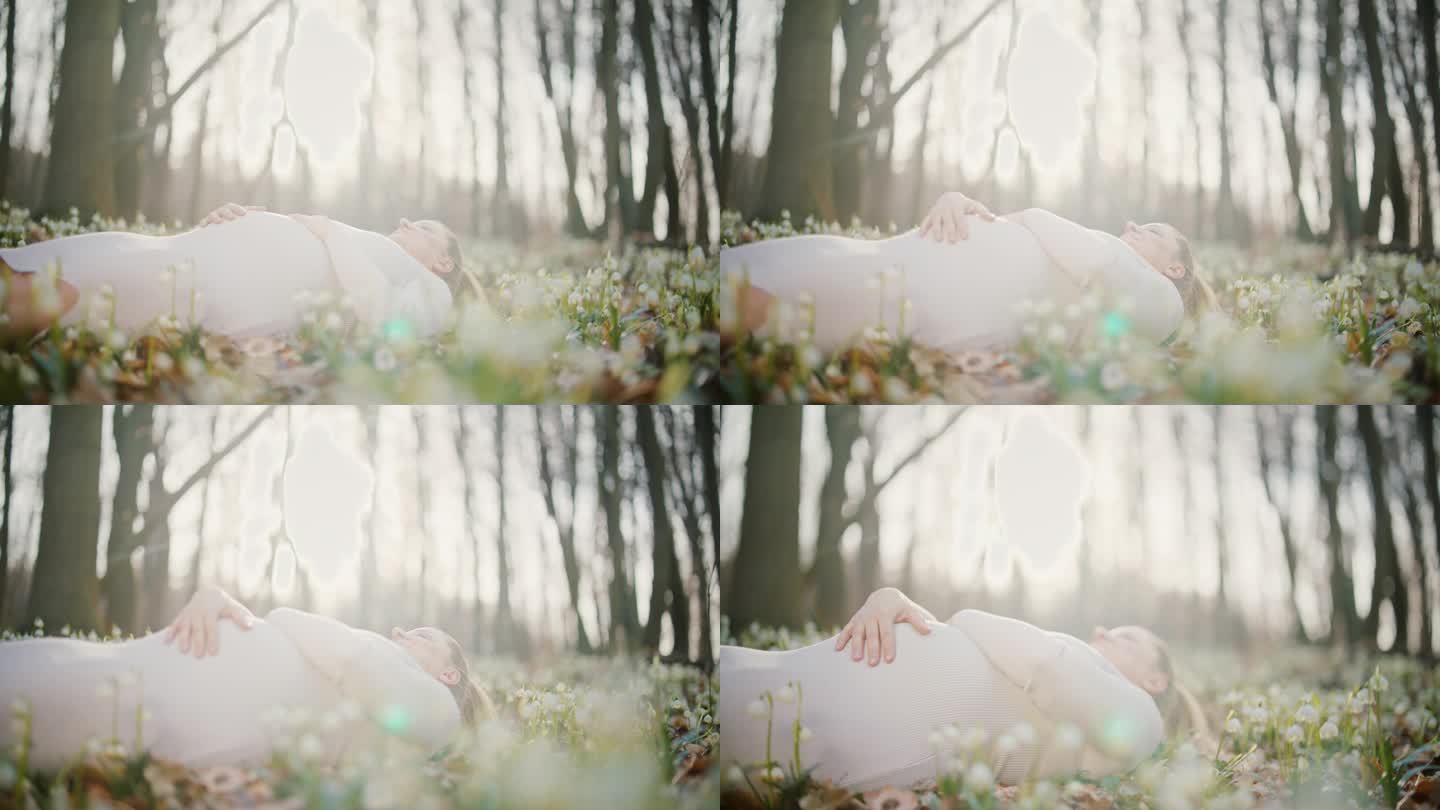 安详的孕妇躺在阳光明媚的树林里的花丛中