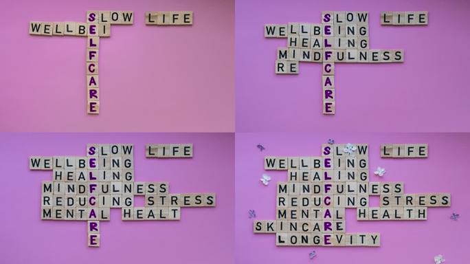 粉红色背景上的SELFCARE字的俯视图的时间流逝。极简创意填字游戏概念。慢生活健康治疗正念减轻压力
