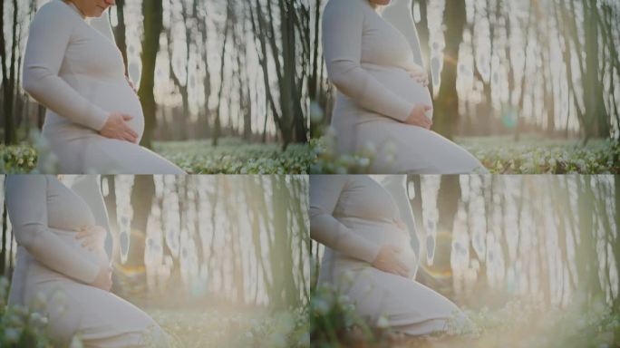 春天的树林里，穿着白色连衣裙的孕妇抱着肚子