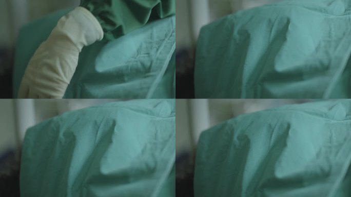 在医院的重症监护室里，医生用绿色床单覆盖着一名躺在医院病床上的死亡男性病人的特写镜头。