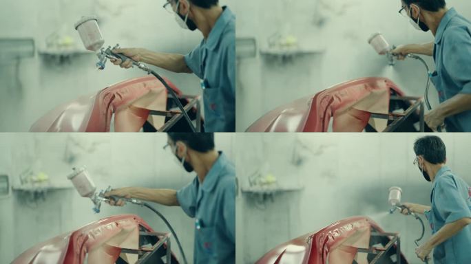 精密汽车涂装:亚洲技师美化保险杠和车身。