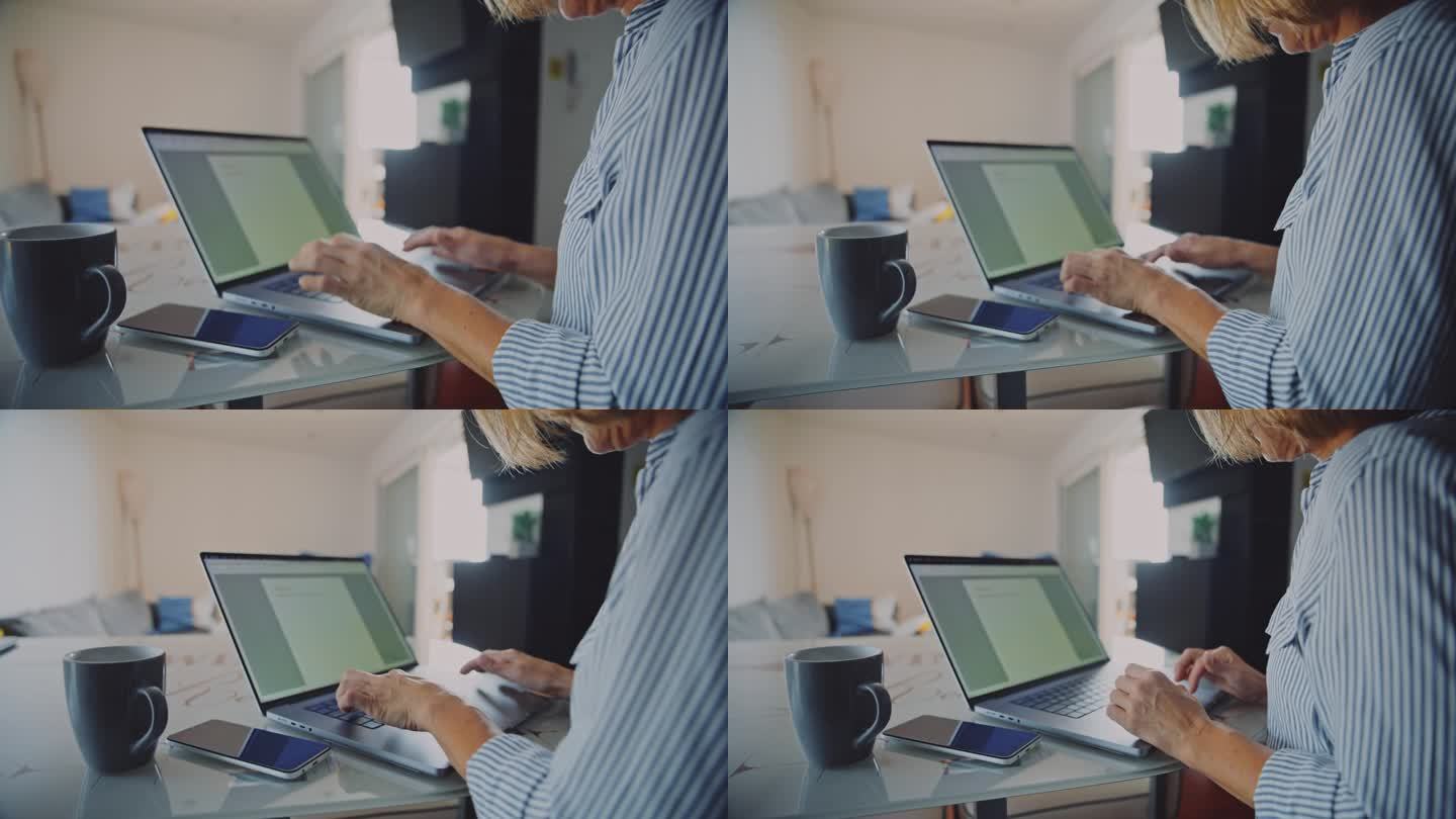 手持拍摄的女人在笔记本电脑上打字，而在家里工作