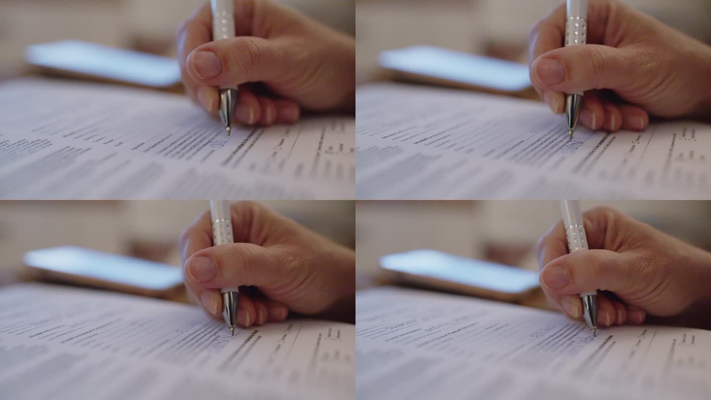 用圆珠笔签署合同的裁剪手特写。合同签名