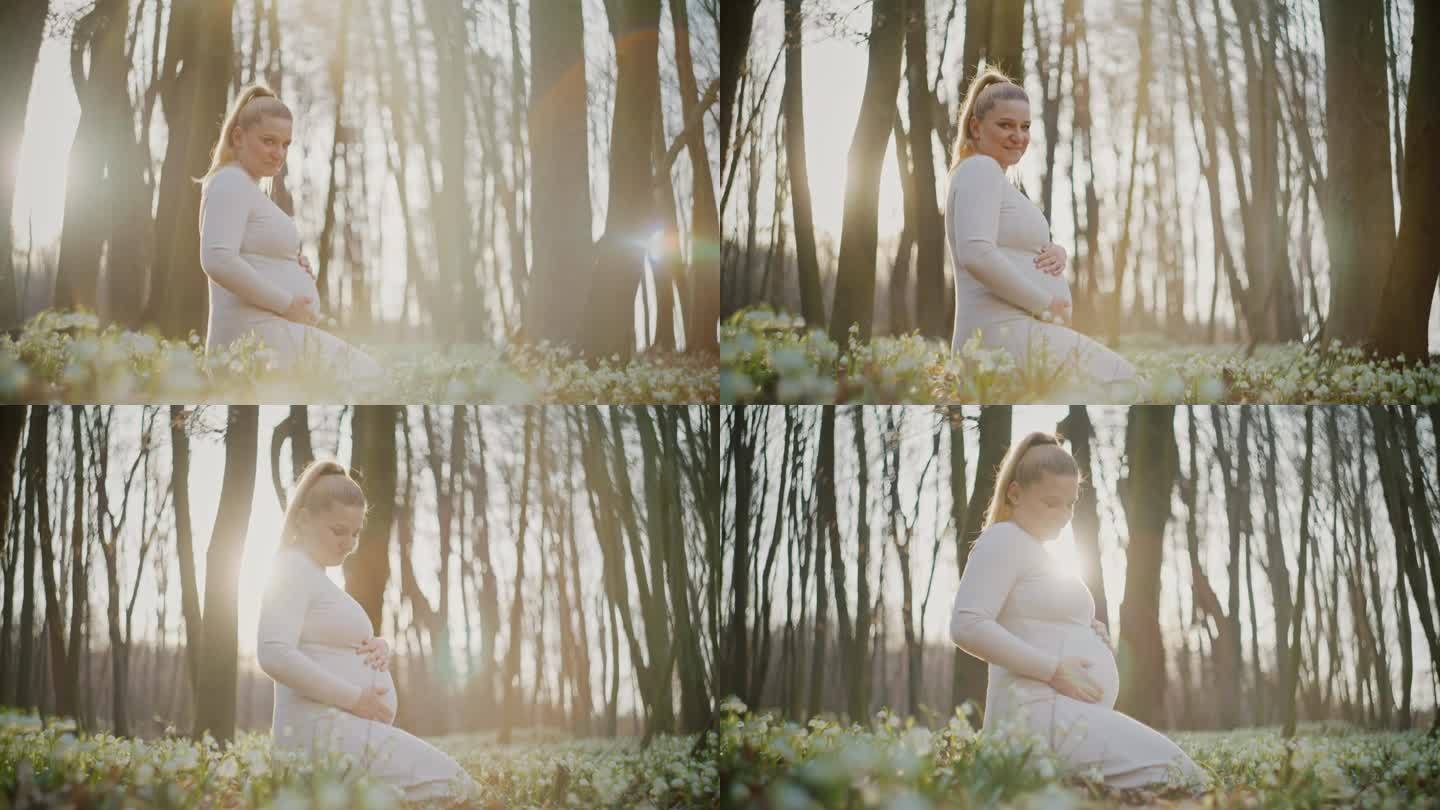 在树林里抱着肚子的孕妇肖像