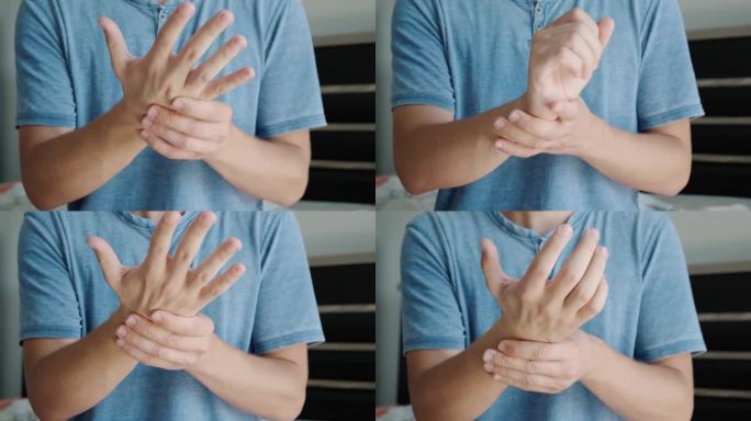 患有手和手腕疼痛的人。男性按摩疼痛的手，从腕管综合症，关节扭伤或关节炎受伤