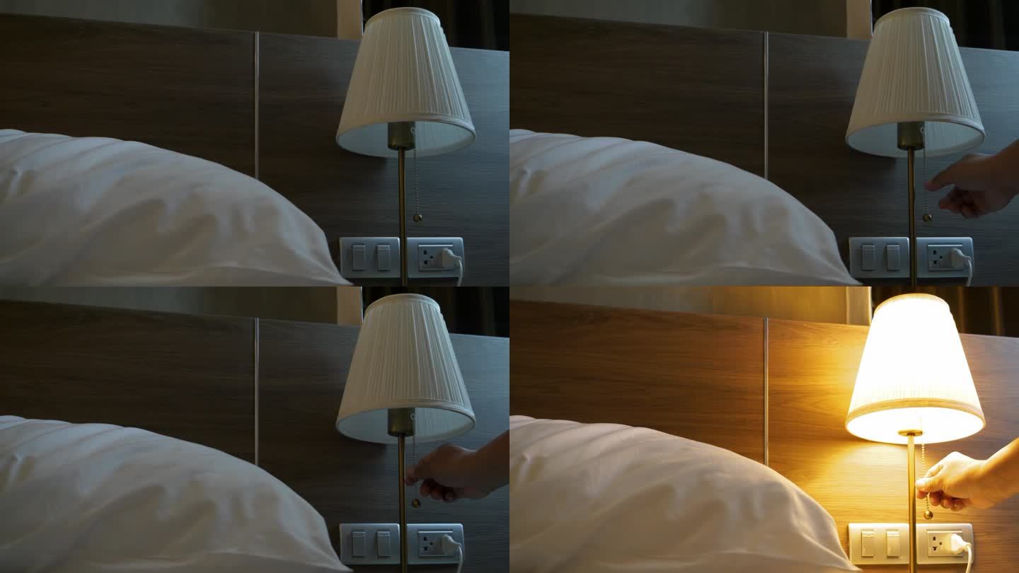 手拉链条开关打开卧室的床头灯。
