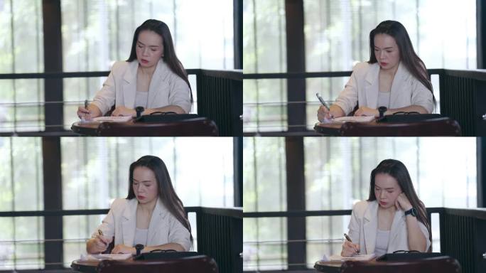 女性在法庭上做笔记的手特写，律师在桌子办公室工作。