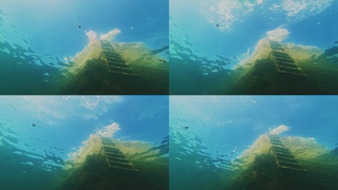 一名女子跳入大海的水下镜头，一名潜水员靠近了她的水下相机