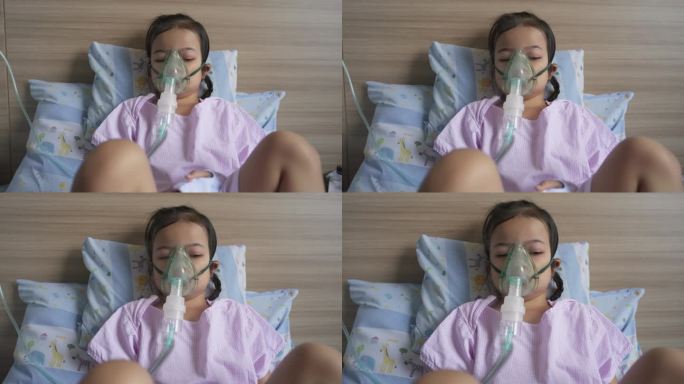 医院里，一个亚洲小女孩戴着呼吸器面罩呼吸。呼吸道合胞病毒支气管炎症状患儿的雾化治疗。哮喘的治疗